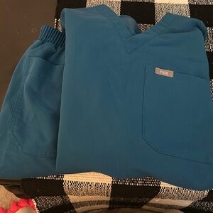 Blue figs scrubs. Straight leg bottom. Both top and bottom are xxs.